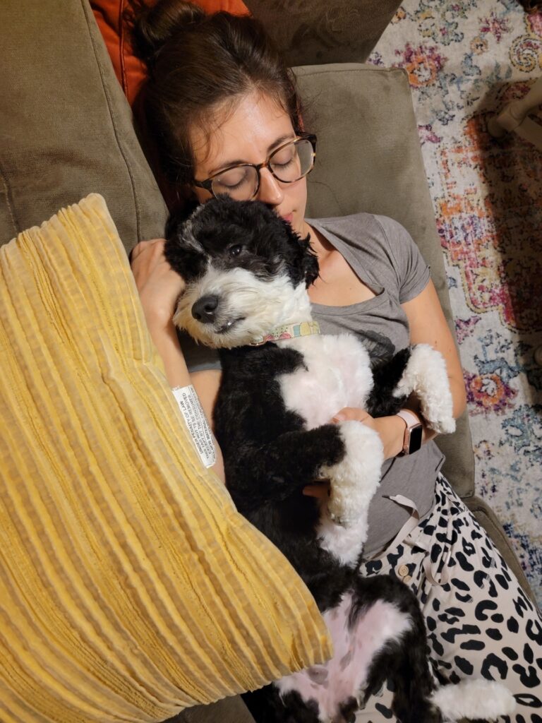 woman cuddling with dog