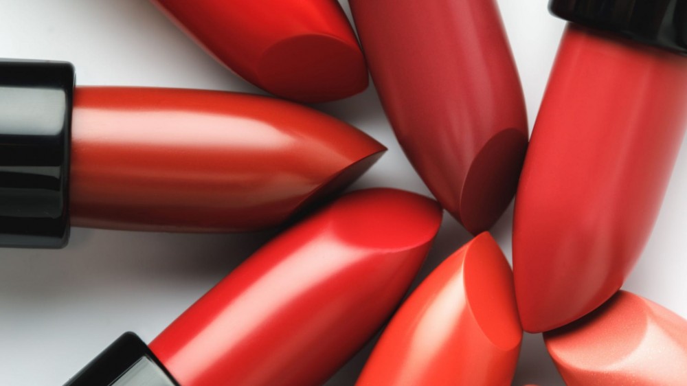 Close-up shot of red lipsticks of different shades on white tabletop.