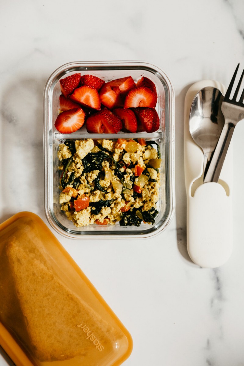 A great vegan meal prep breakfast idea: tofu scramble and toast to go. They're pictured in portable containers.