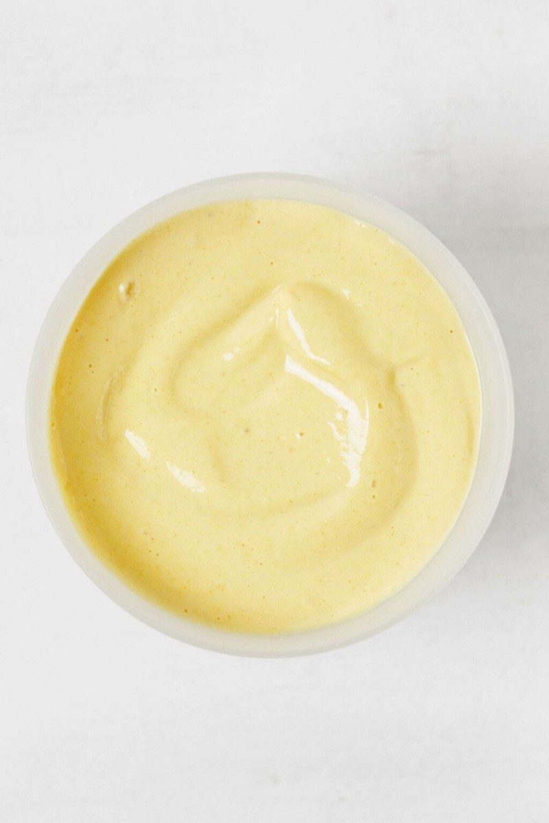 A homemade, liquid vegan egg mixture is in a white bowl, ready to be used.