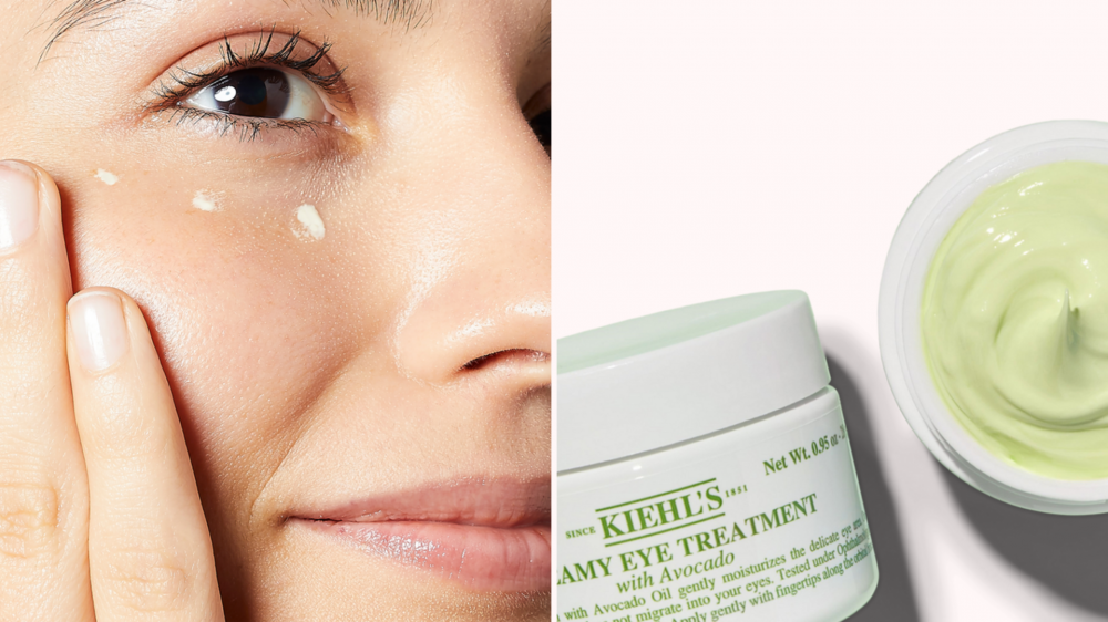 A woman dots eye cream under her eye.