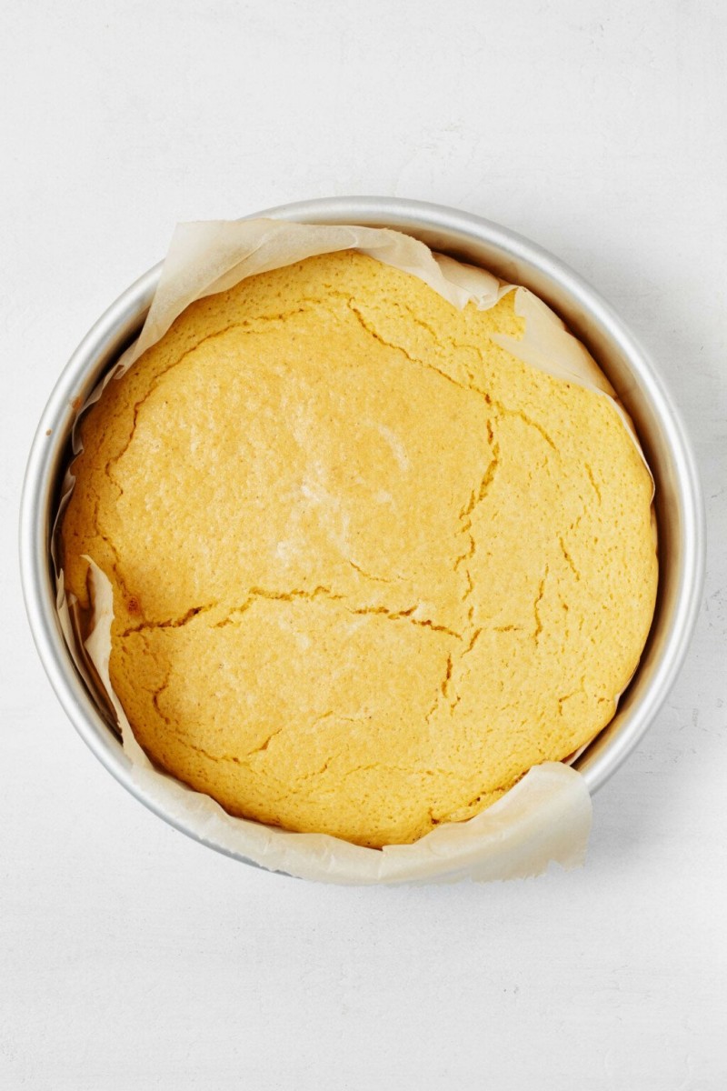 A round cake pan holds a cake made with chickpea flour, which has an eggy taste.