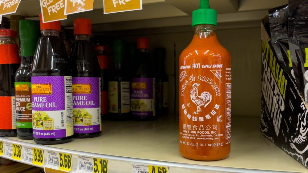 Bottle of sriracha on grocery store shelf