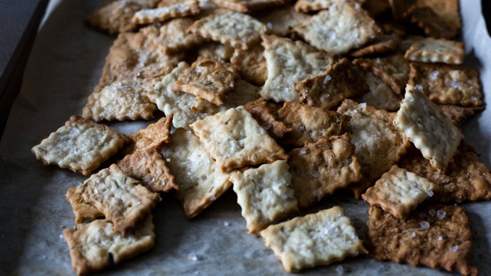 Rosemary and sea salt crackers on a baking sheet