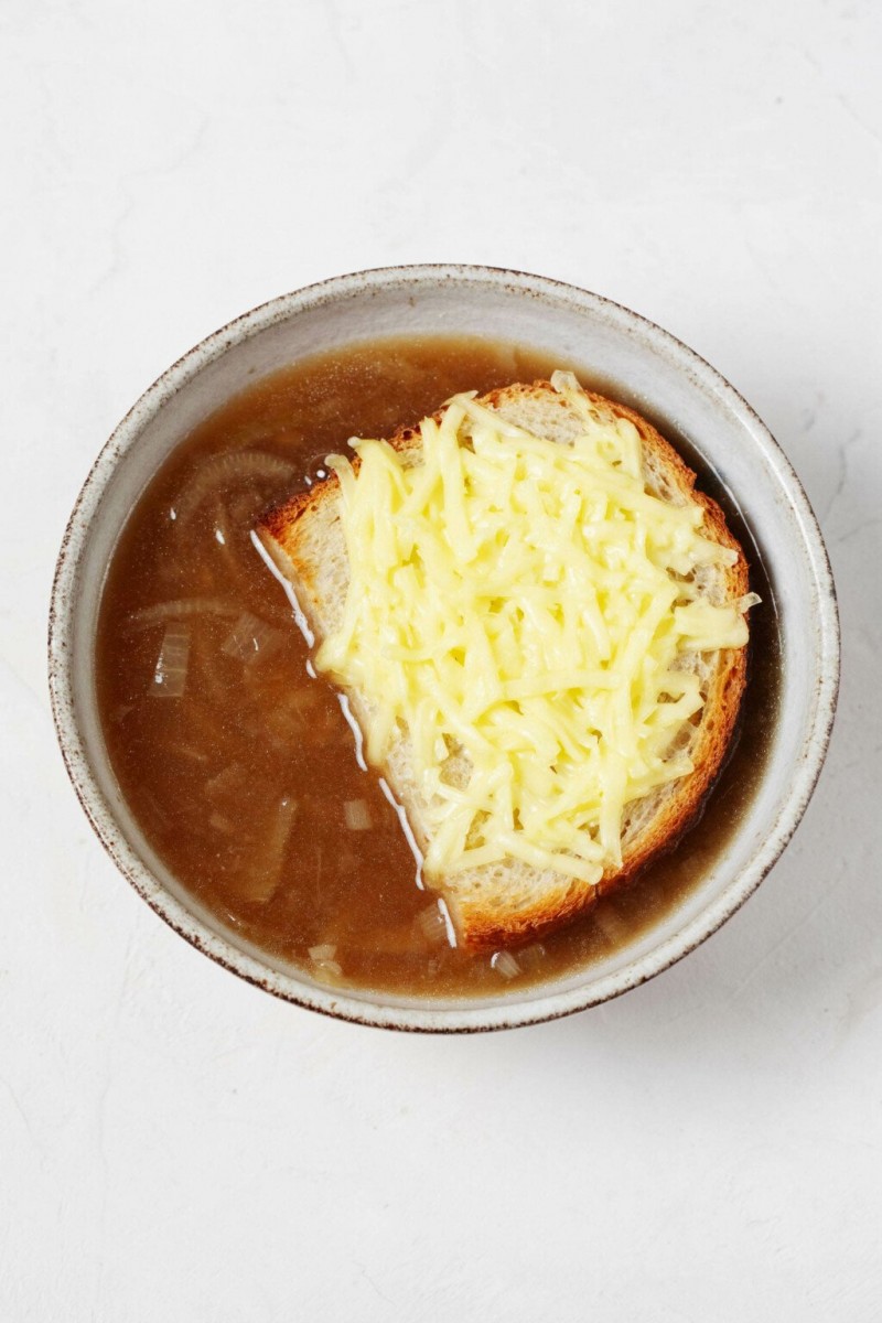 An overhead image of a bowl of French onion soup.